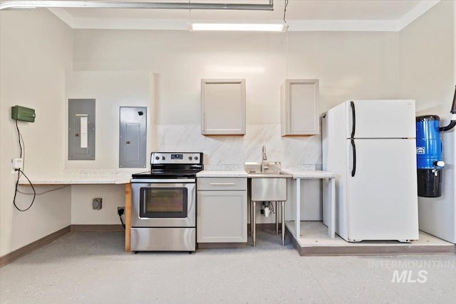 kitchen with light countertops, stainless steel electric range oven, electric panel, and freestanding refrigerator