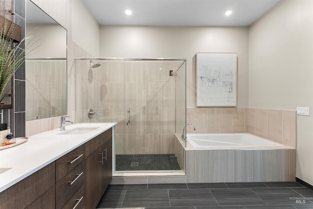 119 S 10th Unit 605, Boise, ID 83702 - bathroom with a bath, a shower stall, double vanity, and recessed lighting