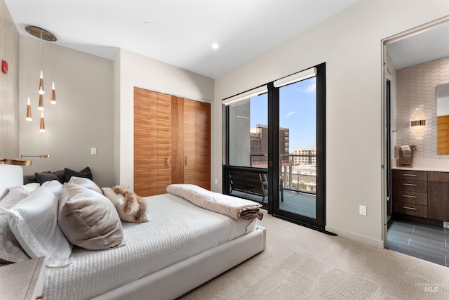 119 S 10th Unit 605, Boise, ID 83702 - bedroom featuring access to outside, light colored carpet, and ensuite bath