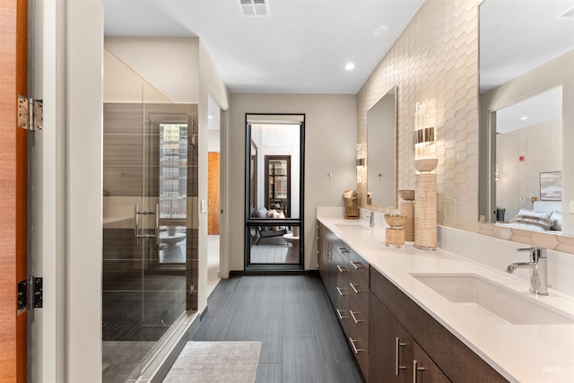 119 S 10th Unit 605, Boise, ID 83702 - bathroom featuring double vanity, a shower stall, and recessed lighting