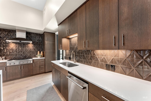 119 S 10th Unit 605, Boise, ID 83702 - kitchen with stainless steel appliances, wall chimney exhaust hood, backsplash, light countertops, and light wood-style floors