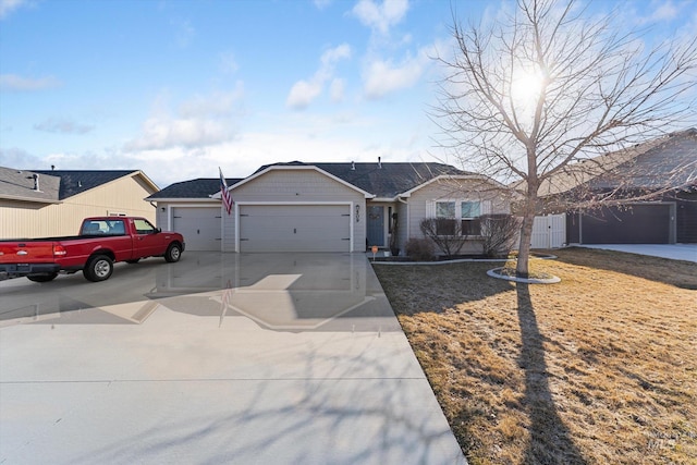 ranch-style home featuring a garage, concrete driveway, fence, and a gate