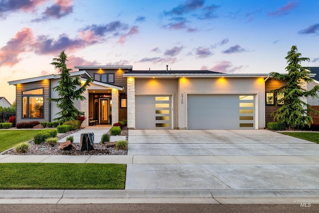 5720 W Little Feather St, Eagle, ID 83616 - modern home with an attached garage, concrete driveway, a front yard, stucco siding, and stone siding