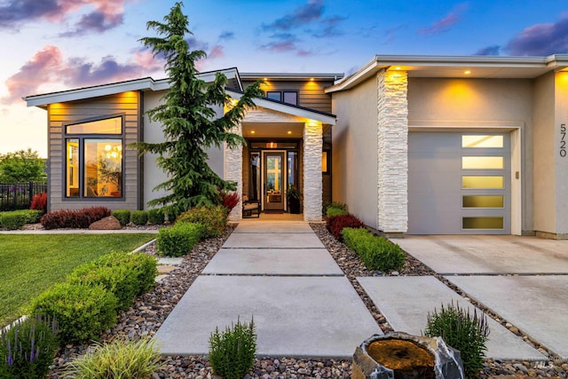 5720 W Little Feather St, Eagle, ID 83616 - view of front facade with stone siding, a garage, driveway, and stucco siding
