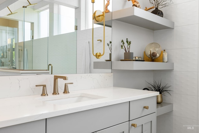 5720 W Little Feather St, Eagle, ID 83616 - bathroom featuring vanity, backsplash, and a stall shower