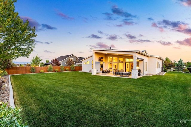 5720 W Little Feather St, Eagle, ID 83616 - back of property at dusk featuring stucco siding and a patio