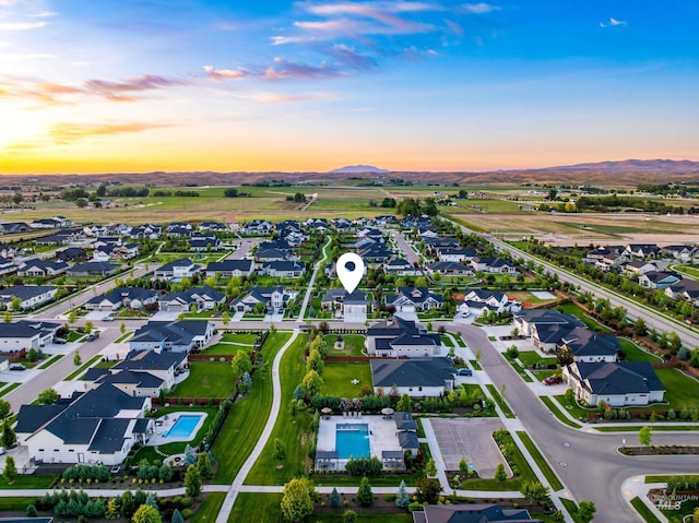 5720 W Little Feather St, Eagle, ID 83616 - view of property location with a mountainous background, a pool, and nearby suburban area
