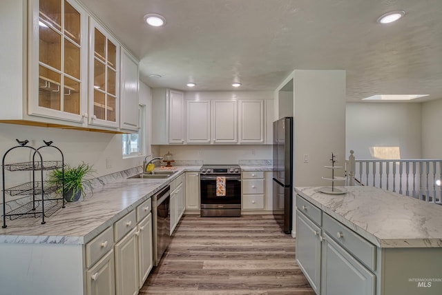 413 S Minnesota Ave, Fruitland, ID 83619 - kitchen with stainless steel appliances, light wood-style flooring, light countertops, recessed lighting, and white cabinets