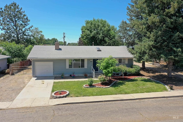 413 S Minnesota Ave, Fruitland, ID 83619 - ranch-style home with a garage, driveway, and a chimney