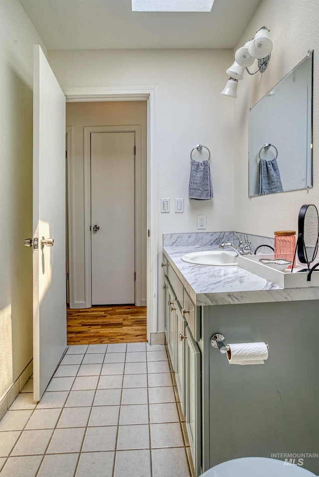 413 S Minnesota Ave, Fruitland, ID 83619 - bathroom featuring vanity, a skylight, and tile patterned floors