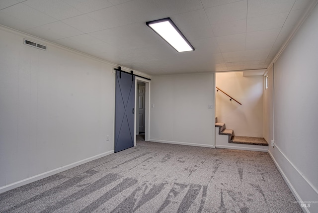 413 S Minnesota Ave, Fruitland, ID 83619 - empty room featuring a barn door, carpet flooring, stairs, and crown molding