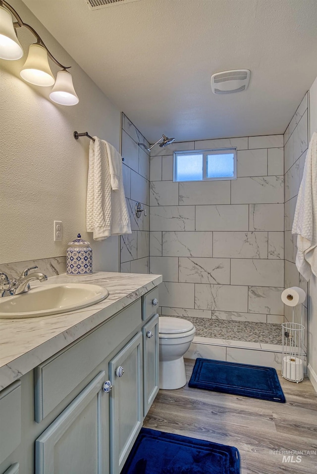 413 S Minnesota Ave, Fruitland, ID 83619 - full bathroom featuring vanity, a stall shower, and wood finished floors