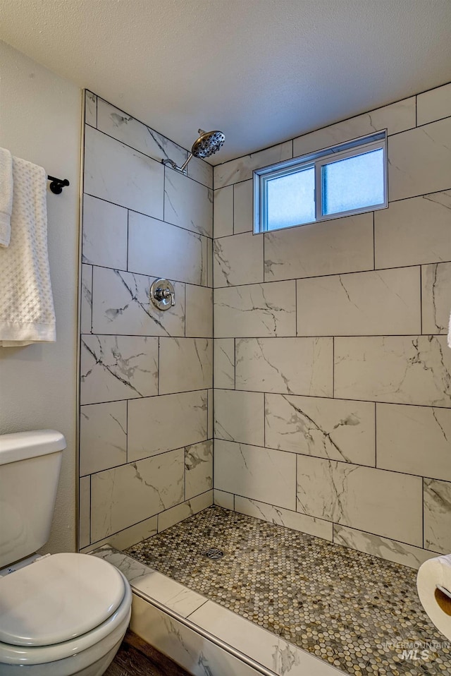 413 S Minnesota Ave, Fruitland, ID 83619 - full bathroom featuring tiled shower and toilet