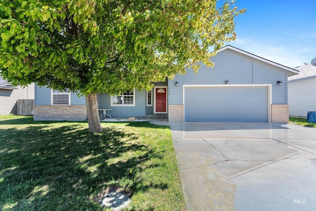 view of front of house featuring brick siding, an attached garage, driveway, and a front yard