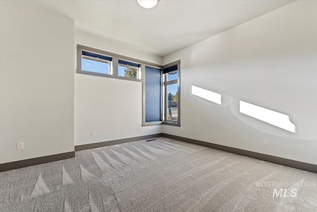 empty room featuring light colored carpet