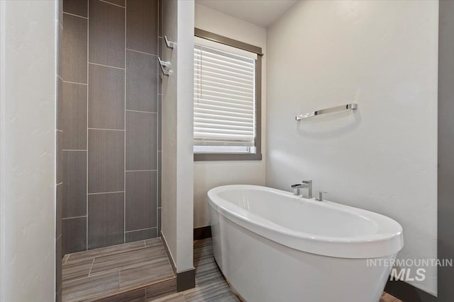 bathroom featuring separate shower and tub