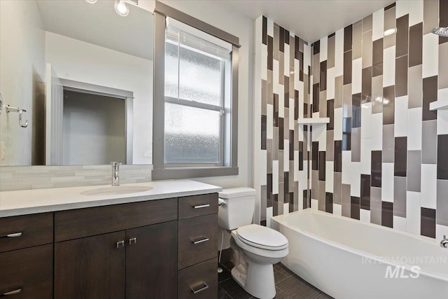 full bathroom with tile patterned floors, vanity, decorative backsplash, toilet, and shower / bathtub combination