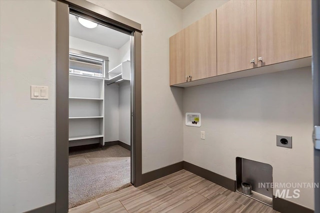 laundry area with light carpet, electric dryer hookup, cabinets, and washer hookup