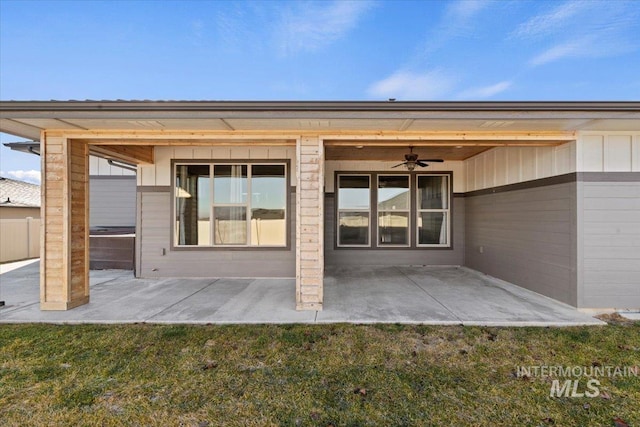 rear view of property featuring a patio area, a lawn, and ceiling fan