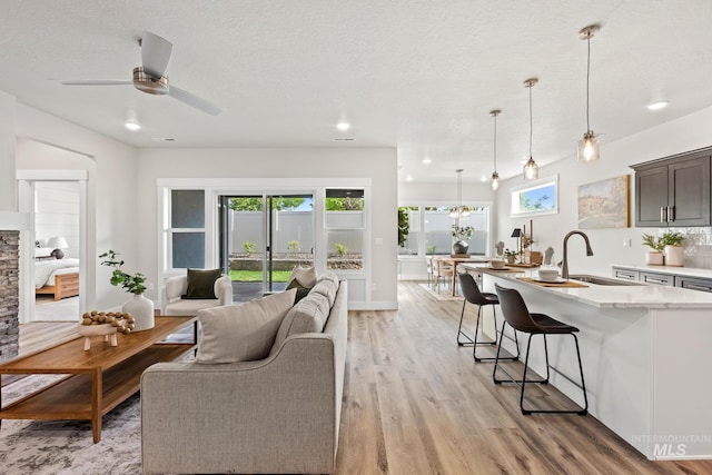 1753 E Grayson, Meridian, ID 83642 - living room with light wood-style floors, recessed lighting, ceiling fan, and a textured ceiling