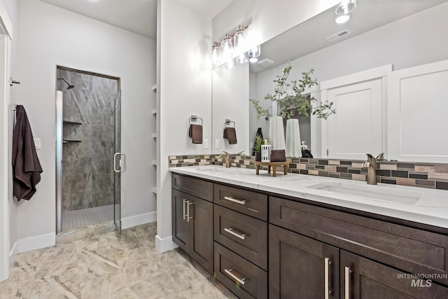 1753 E Grayson, Meridian, ID 83642 - full bathroom with baseboards, double vanity, a stall shower, tasteful backsplash, and marble look tiles