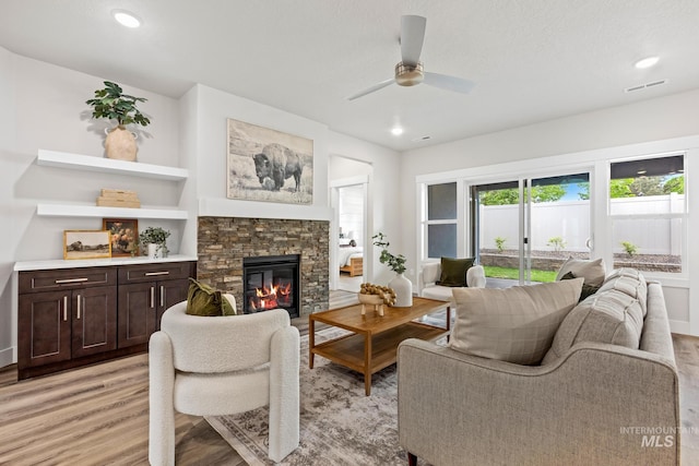 1753 E Grayson, Meridian, ID 83642 - living room with light wood-style floors, ceiling fan, a fireplace, recessed lighting, and baseboards