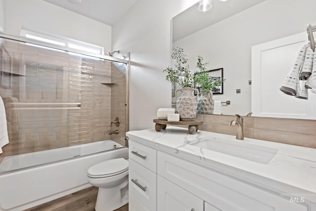 1753 E Grayson, Meridian, ID 83642 - bathroom with vanity, toilet, wood finished floors, and bath / shower combo with glass door