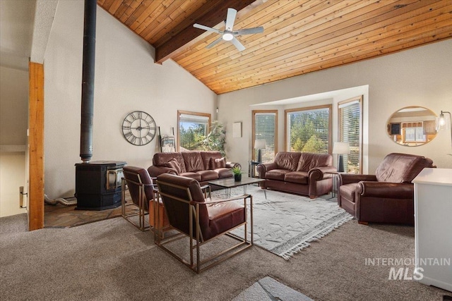 502 Lake Cascade Pkwy Unit 6, Cascade, ID 83611 - living room featuring a wood stove, carpet flooring, a ceiling fan, wood ceiling with exposed beams, and high vaulted ceiling