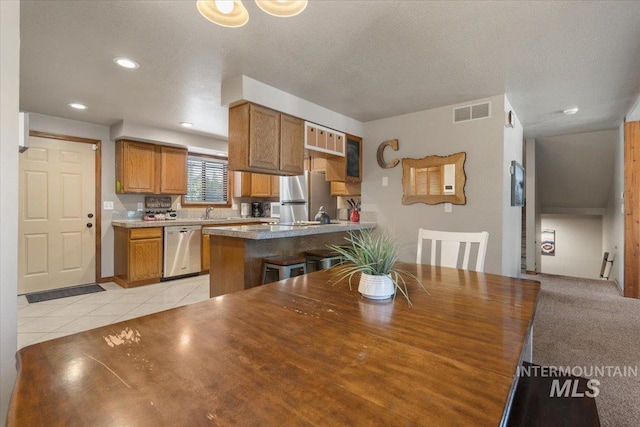 502 Lake Cascade Pkwy Unit 6, Cascade, ID 83611 - dining area with light tile patterned floors, recessed lighting, and a textured ceiling