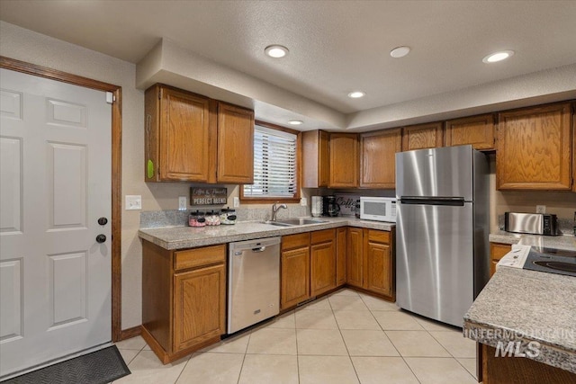 502 Lake Cascade Pkwy Unit 6, Cascade, ID 83611 - kitchen featuring stainless steel appliances, a sink, brown cabinetry, light countertops, and recessed lighting