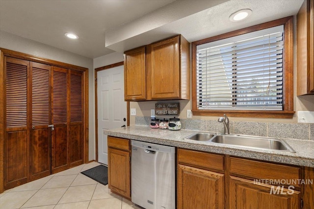 502 Lake Cascade Pkwy Unit 6, Cascade, ID 83611 - kitchen featuring dishwasher, a sink, light tile patterned flooring, light countertops, and brown cabinetry