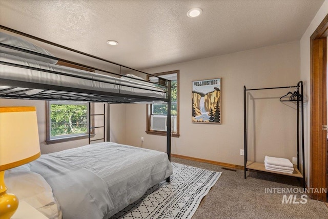 502 Lake Cascade Pkwy Unit 6, Cascade, ID 83611 - carpeted bedroom with multiple windows, baseboards, a textured ceiling, recessed lighting, and cooling unit