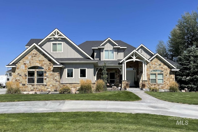 craftsman-style house with board and batten siding and a front lawn