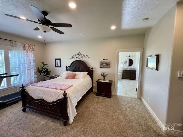 carpeted bedroom with a ceiling fan, recessed lighting, baseboards, and a textured ceiling