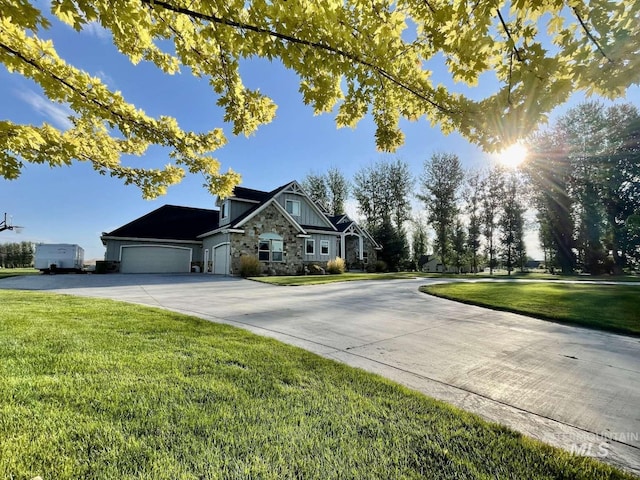 view of front of house with concrete driveway, an attached garage, stone siding, and a front lawn