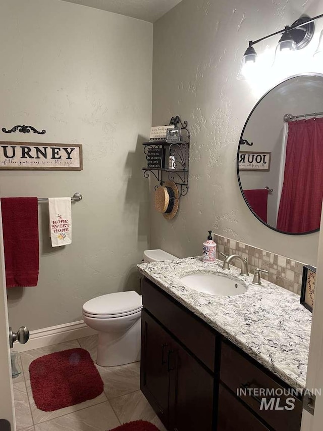 full bathroom with vanity, decorative backsplash, toilet, and tile patterned floors