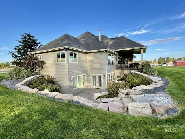 back of house with a lawn and french doors