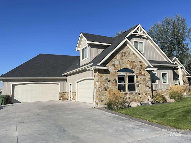 craftsman house featuring driveway, an attached garage, board and batten siding, and a front lawn