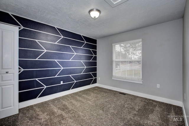 empty room featuring baseboards, visible vents, carpet floors, and a textured ceiling