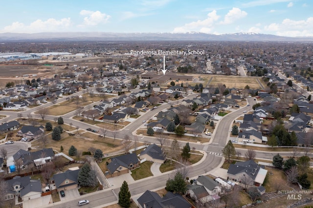 birds eye view of property with a mountain view and a residential view