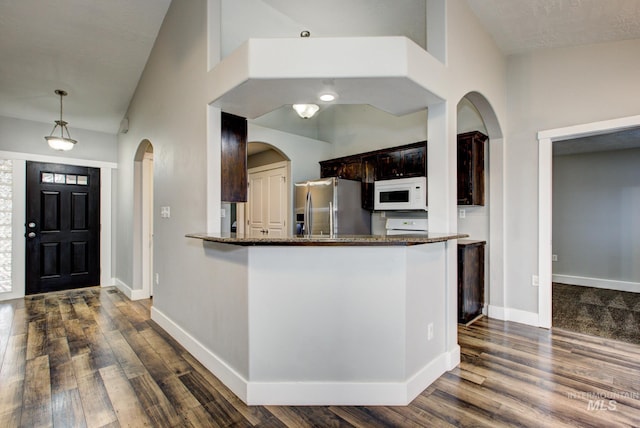 kitchen with baseboards, dark wood-type flooring, white microwave, and stainless steel fridge with ice dispenser