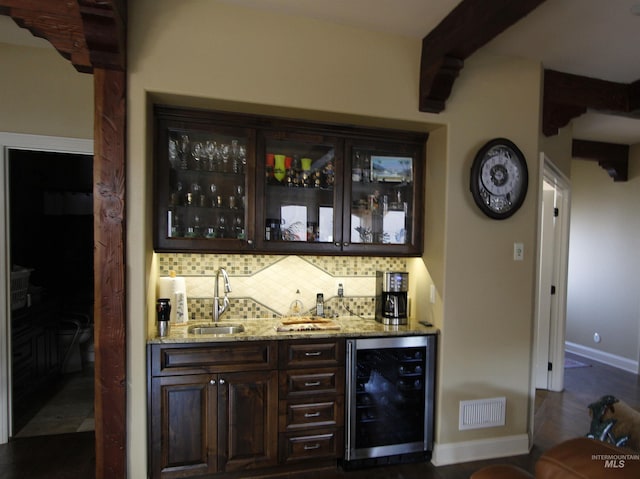 bar featuring a sink, indoor wet bar, decorative backsplash, wine cooler, and beamed ceiling