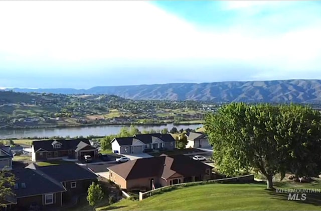 bird's eye view featuring a water and mountain view and a residential view