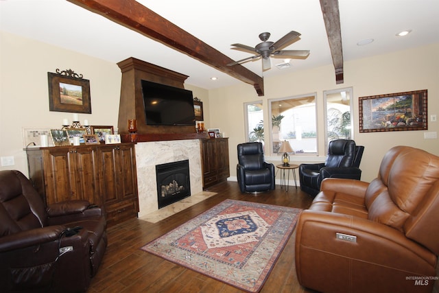 living room featuring a premium fireplace, hardwood / wood-style floors, a ceiling fan, beamed ceiling, and visible vents