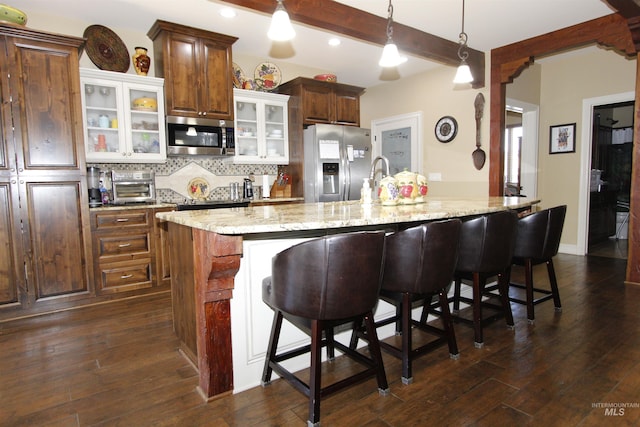 kitchen featuring tasteful backsplash, stainless steel appliances, beam ceiling, and dark wood-type flooring