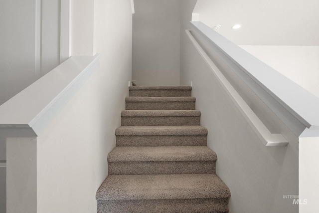 stairs featuring recessed lighting