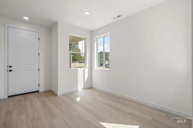 entryway featuring light wood-style flooring, visible vents, baseboards, and recessed lighting