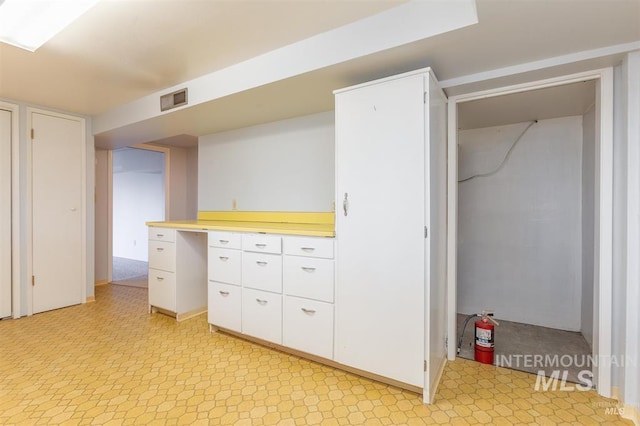 1605 Vineyard Dr, Lewiston, ID 83501 - kitchen with light floors, white cabinetry, and light countertops