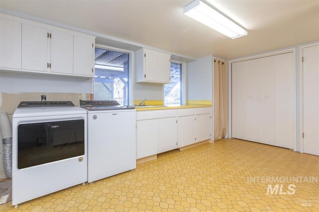 1605 Vineyard Dr, Lewiston, ID 83501 - washroom with washing machine and dryer, cabinet space, and light floors