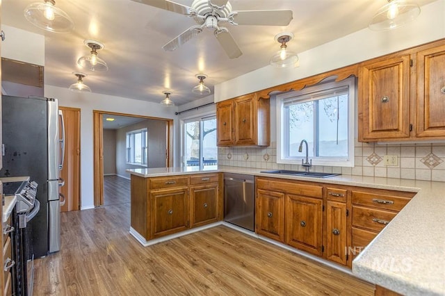 1605 Vineyard Dr, Lewiston, ID 83501 - kitchen featuring appliances with stainless steel finishes, a peninsula, and brown cabinetry
